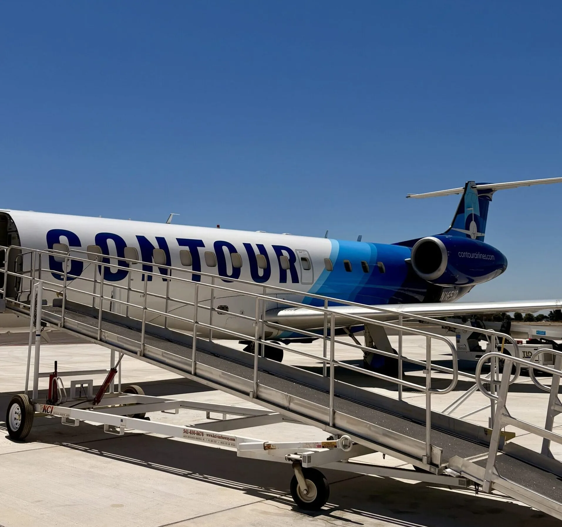 Airstairs rolled up to a Contour Airlines jet on the tarmac