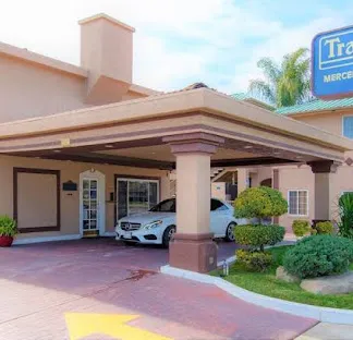 travelodge hotel entrance with a mercedes parked near the door