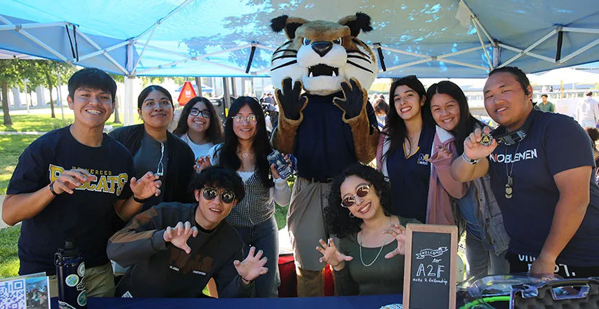 UC Merced students participating in a campus event with the Rufus the Bobcat mascot, highlighting student organizations and university life in Merced.