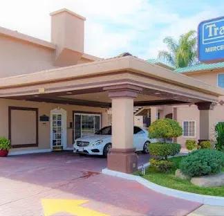 travelodge hotel entrance with a mercedes parked near the door