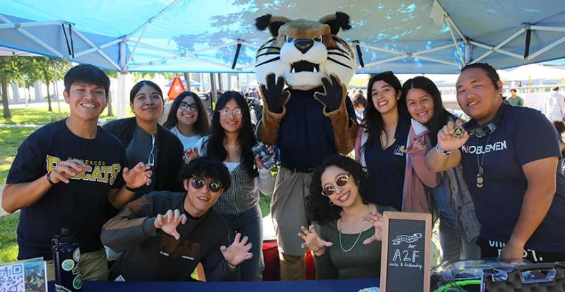 UC Merced students participating in a campus event with the Rufus the Bobcat mascot, highlighting student organizations and university life in Merced.